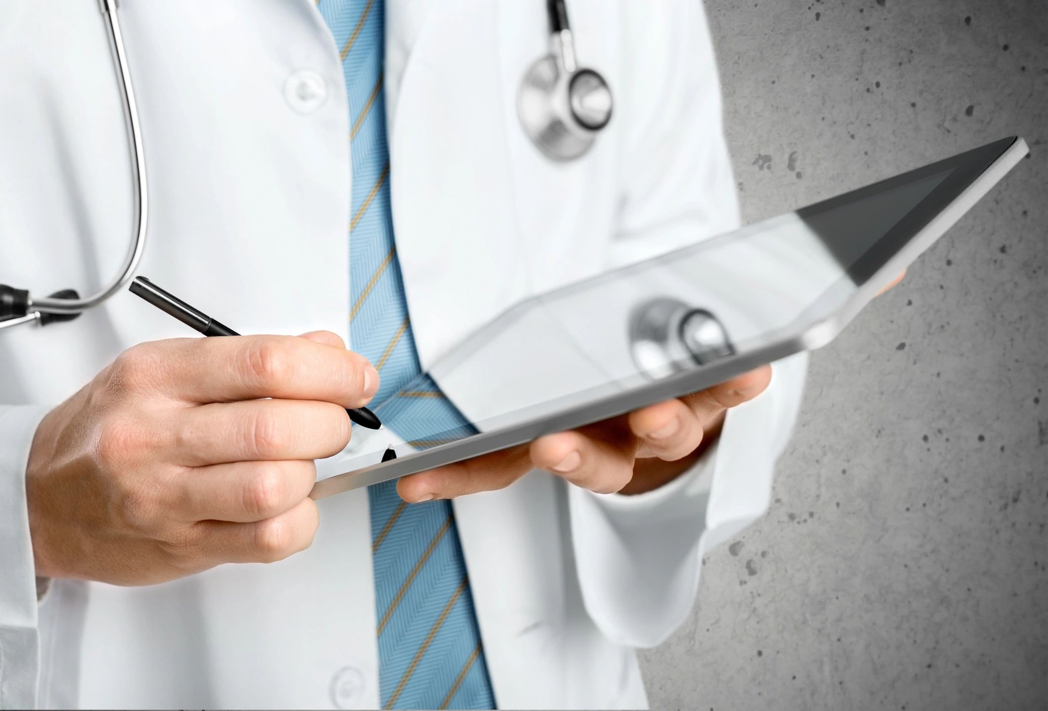male doctor holding an ipad