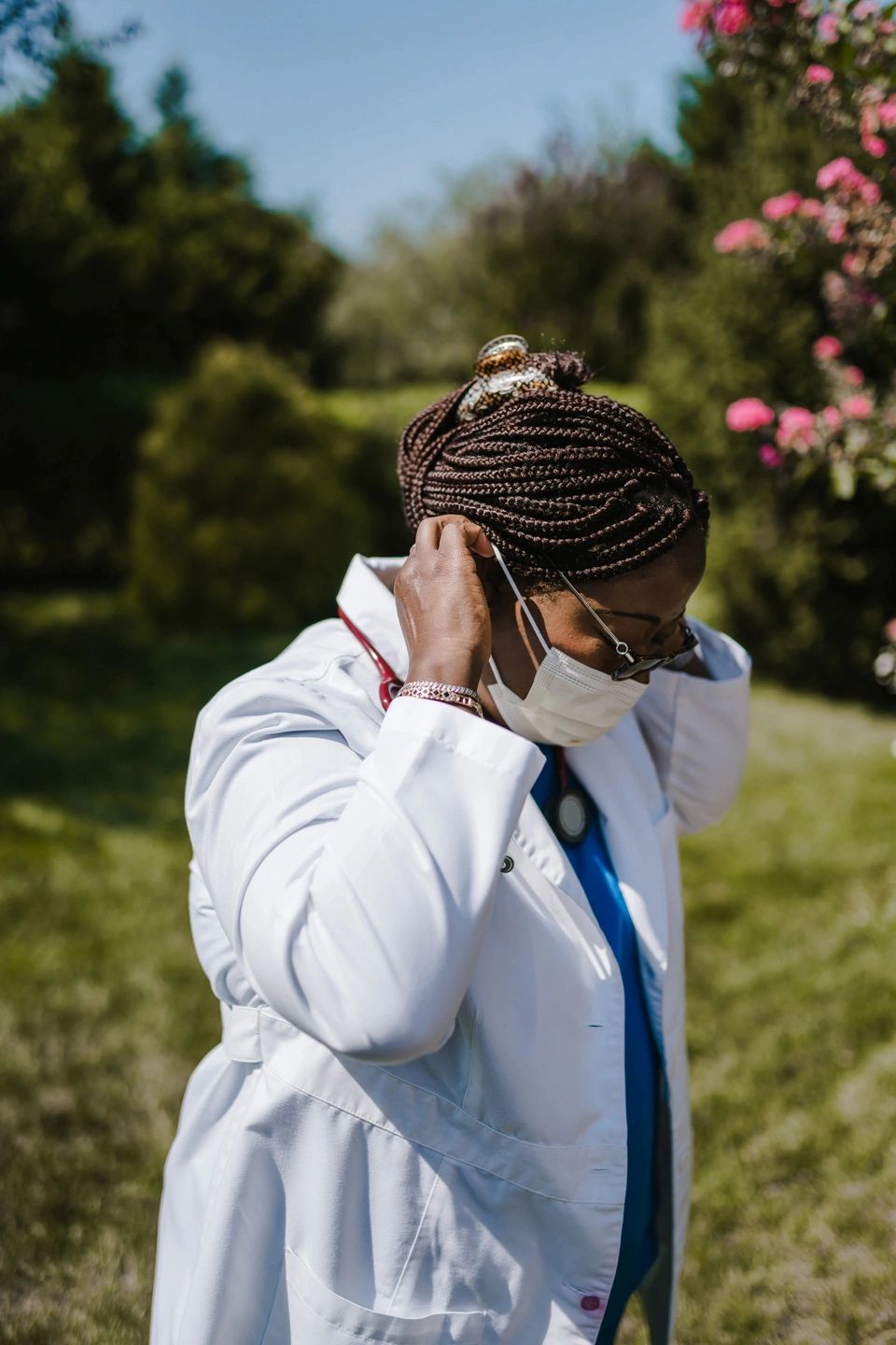 doctor putting on a mask in white coat